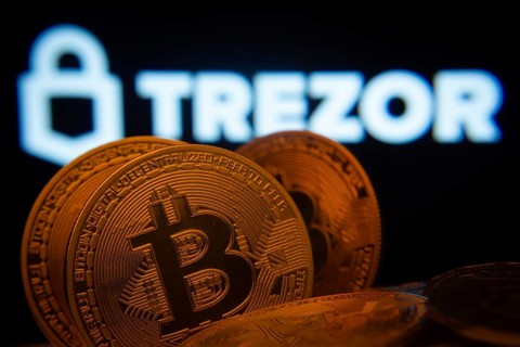 Dhaka, Bangladesh- 20 Sep 2025: Close-up of Bitcoin coins with the Trezor logo visible on a screen