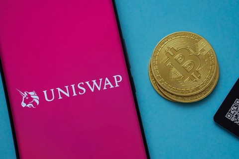 Dhaka, Bangladesh- 19 Sep 2025: Uniswap logo on smartphone screen near Bitcoin coin and QR code on