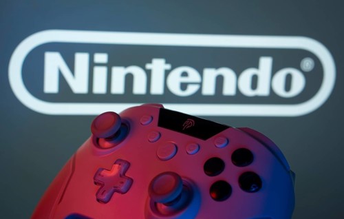 Dhaka, Bangladesh- 15 July 2025: A close-up of a gamepad with the nintendo seen on screen in the
