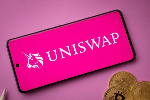 Dhaka, Bangladesh- 15 June 2025: Uniswap logo on smartphone screen near Bitcoin coin and QR code on