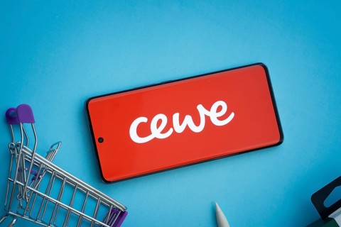 Dhaka, Bangladesh- 03 July 2025: Smartphone displaying Cewe logo with shopping cart on a blue