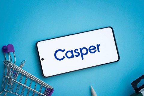 Dhaka, Bangladesh- 03 July 2025: Smartphone displaying Casper logo with shopping cart on a blue