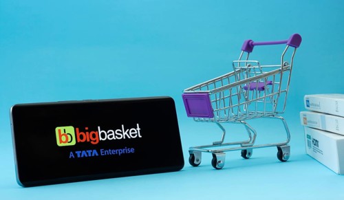 Dhaka, Bangladesh- 03 July 2025: Smartphone with BigBasket logo next to a small shopping cart and