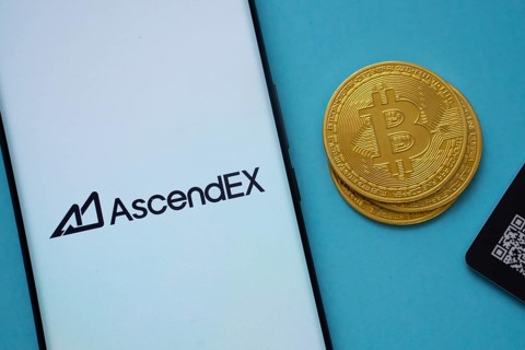 Dhaka, Bangladesh- 02 June 2025: AscendEX logo on smartphone screen near Bitcoin coin and QR code