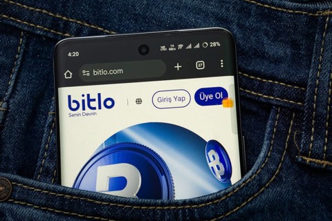 Dhaka, Bangladesh- 15 June 2025: A smartphone displaying the Bitlo.com web interface peeks out of a