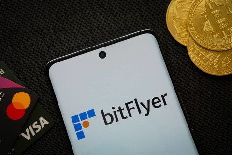 Dhaka, Bangladesh- 02 June 2025: Smartphone displaying Bitflyer logo surrounded by Bitcoin coins