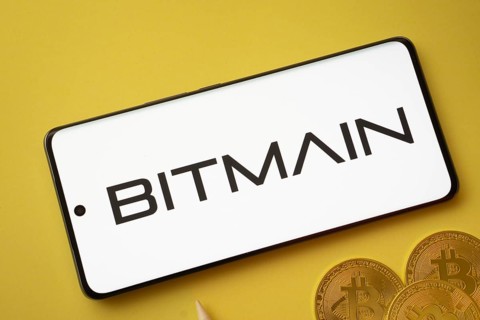 Dhaka, Bangladesh- 15 June 2025: Bitmain logo on smartphone screen near Bitcoin coin and QR code on