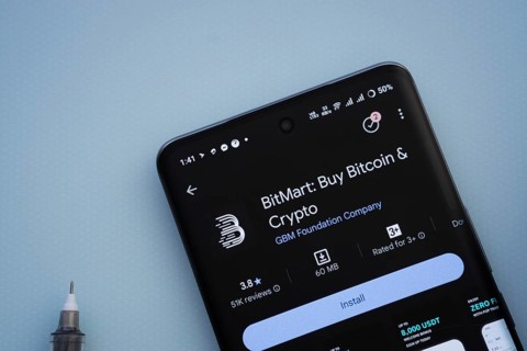 Dhaka, Bangladesh- 29 May 2025: On a blue surface, a smartphone displays the BitMart app within the