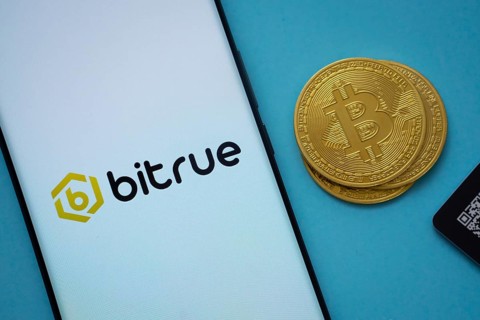 Dhaka, Bangladesh- 03 Sep 2025: Bitrue logo on smartphone screen near Bitcoin coin and QR code on