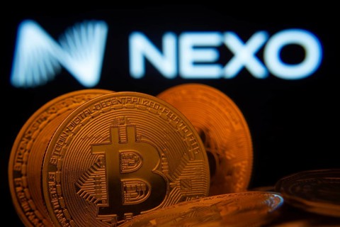 Dhaka, Bangladesh- 06 Sep 2025: Close-up of Bitcoin coins with the Nexo logo visible on a screen in
