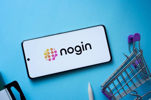 Dhaka, Bangladesh- 03 July 2025: Smartphone displaying nogin logo with shopping cart on a blue