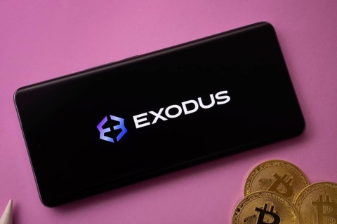 Dhaka, Bangladesh- 06 Sep 2025: Exodus logo on smartphone screen near Bitcoin coin and QR code on