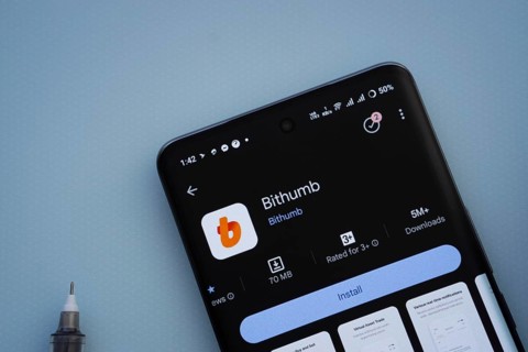 Dhaka, Bangladesh- 07 May 2025: On a blue surface, a smartphone displays the Bithumb app within the