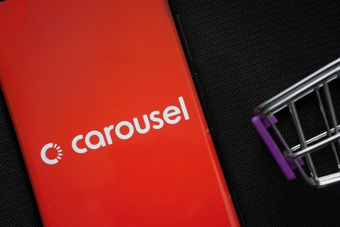 Dhaka, Bangladesh- 03 July 2025: A smartphone displaying the Carousell logo next to a miniature