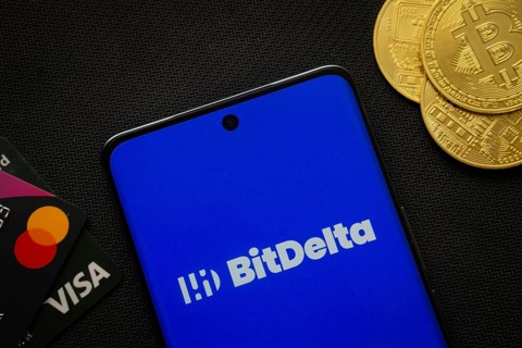 Dhaka, Bangladesh- 02 June 2025: Smartphone displaying BitDelta logo surrounded by Bitcoin coins