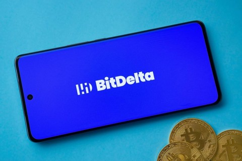 Dhaka, Bangladesh- 02 June 2025: BitDelta logo on smartphone screen near Bitcoin coin and QR code
