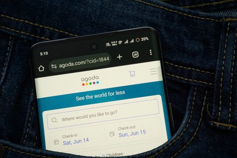 Dhaka, Bangladesh- 15 June 2025: A smartphone displaying the Agoda.com web interface peeks out of a