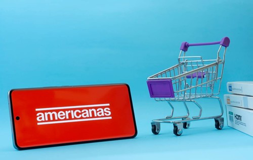 Dhaka, Bangladesh- 03 July 2025: Smartphone with Americanas logo next to a small shopping cart and
