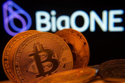 Dhaka, Bangladesh- 15 June 2025: Close-up of Bitcoin coins with the bigONE logo visible on a screen