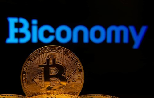 Dhaka, Bangladesh- 02 June 2025: Close-up of Bitcoin coins with the Biconomy logo visible on a