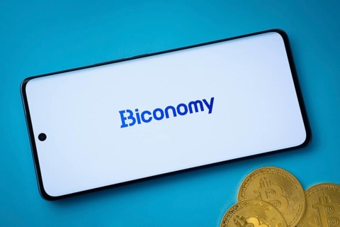 Dhaka, Bangladesh- 02 June 2025: Biconomy logo on smartphone screen near Bitcoin coin and QR code