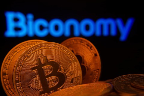 Dhaka, Bangladesh- 03 Sep 2025: Close-up of Bitcoin coins with the Biconomy logo visible on a