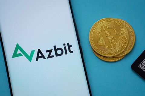 Dhaka, Bangladesh- 02 June 2025: Azbit logo on smartphone screen near Bitcoin coin and QR code on