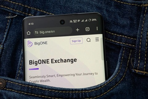 Dhaka, Bangladesh- 15 June 2025: A smartphone displaying the BigONE web interface peeks out of a