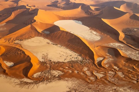 Sand dunes and dry pans in the Namib Desert. In the evening. Aerial view. Namib-Naukluft Park,
