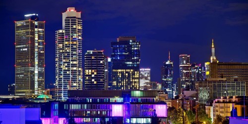 Rooftop day with colourfully illuminated houses for a techno party on the roof with a view of the