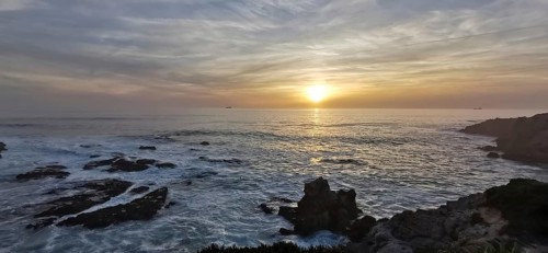 A breathtaking sunset over a rocky and wild coast, hiking the Fisherman's trail, Rota Vicentina,