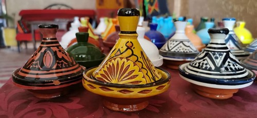 Colourful ceramic tajines in traditional Moroccan designs on a table, Morocco