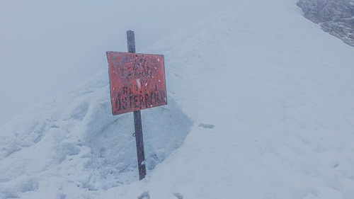 Snow-covered landscape with a sign Republic of Austria, on the way to Zugspitze during snowstorm,
