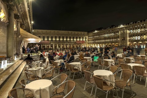 Café visitors at night concert in St. Mark's Square, Venice, Veneto, Italy