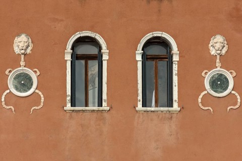 Sculptures of lion heads on a house wall, Venice, Veneto, Italy