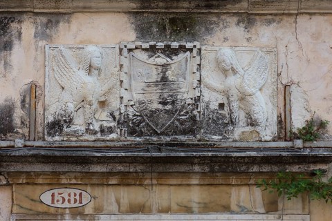 Relief over an entrance valley, two hybrid creatures, chimeras holding a coat of arms, Venice,