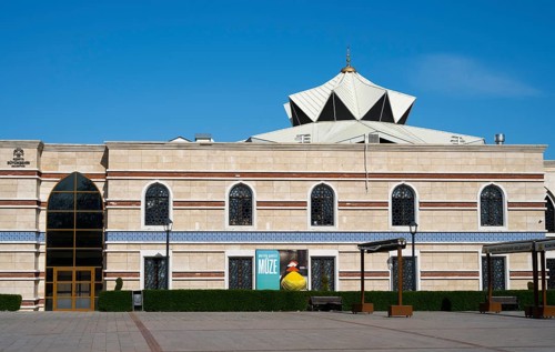 Modern building with a distinctive roof and numerous rows of windows, Irfan Medeniyeti Arastirma ve