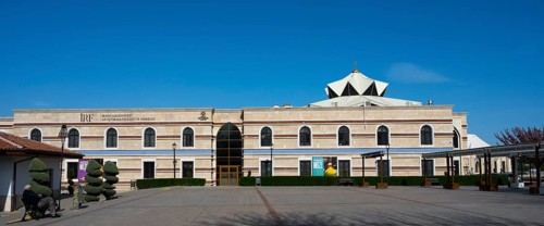 Long modern building with a flat roof and turquoise elements, Irfan Medeniyeti Arastirma ve Kültür