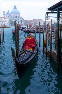 Gondolas anchor in the Grand Canal, Santa Maria della Salute in the back, Venice, Veneto, Italy