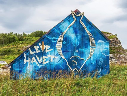 Painted colorful boathouse, text 'live the sea', island Kvaloya, Norway