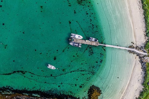 Leisure boats at the jetty, sandy beach, island Sommaroy, top down aerial view, Norway