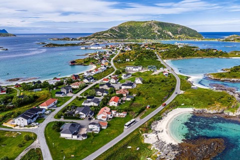 Aerial view over island Sommaroy, sandy beaches, mountain with radar station, Norway