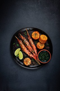 Langoustines on skewers, shrimp kebab, with fried corn, spices and herbs, homemade, no people
