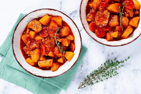 Meat goulash with potatoes and carrots, sweet peppers, in a saucepan, top view, traditional