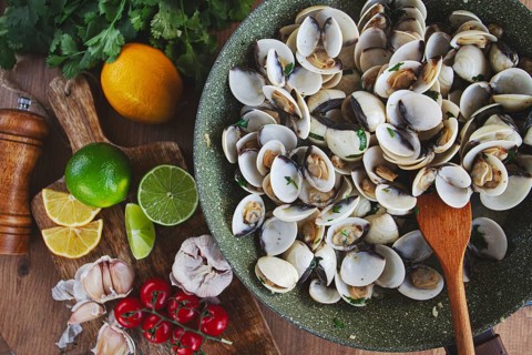 Cooking, vongole clams, in a pan with spices and white wine, top view, no people