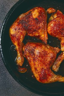 Baked chicken legs, with crispy skin, served in a pan, rustic style, homemade, no people