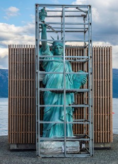Art object, Statue of Liberty in a cage, village Lyngen, Lyngen Alps, Norway