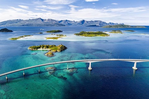 Sommaroy Bridge connecting Kvaloya Island to Sommaroy Island, small islands, mountain range in the