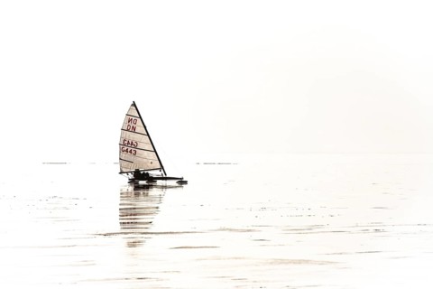Ice sailor on the frozen Dümmer Lake on a brightly lit, minimalist-looking lake, Lembruch, Lower