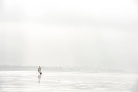 Ice sailors on foggy water, calm and melancholy atmosphere on frozen Dümmer See, Lembruch, Lower